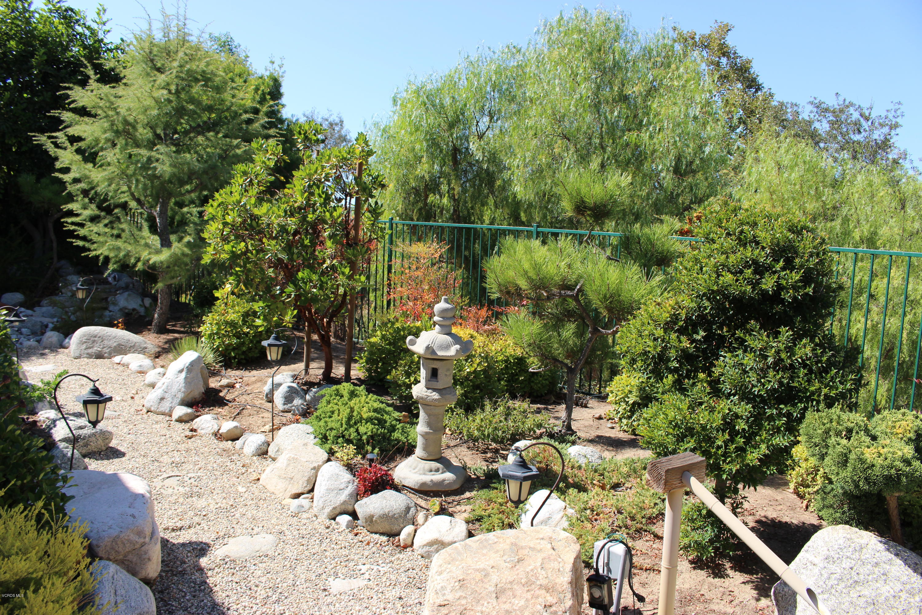605 Galloping Hill Road Simi Valley, CA 93065 - Photo 30 of 35 a view of a lake with lawn chairs and iron fence