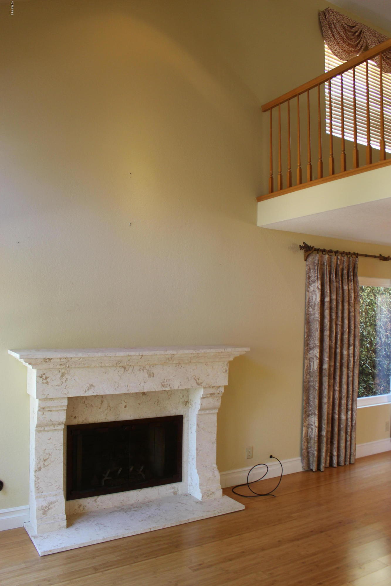 605 Galloping Hill Road Simi Valley, CA 93065 - Photo 8 of 35 a view of an empty room with wooden floor and a fireplace