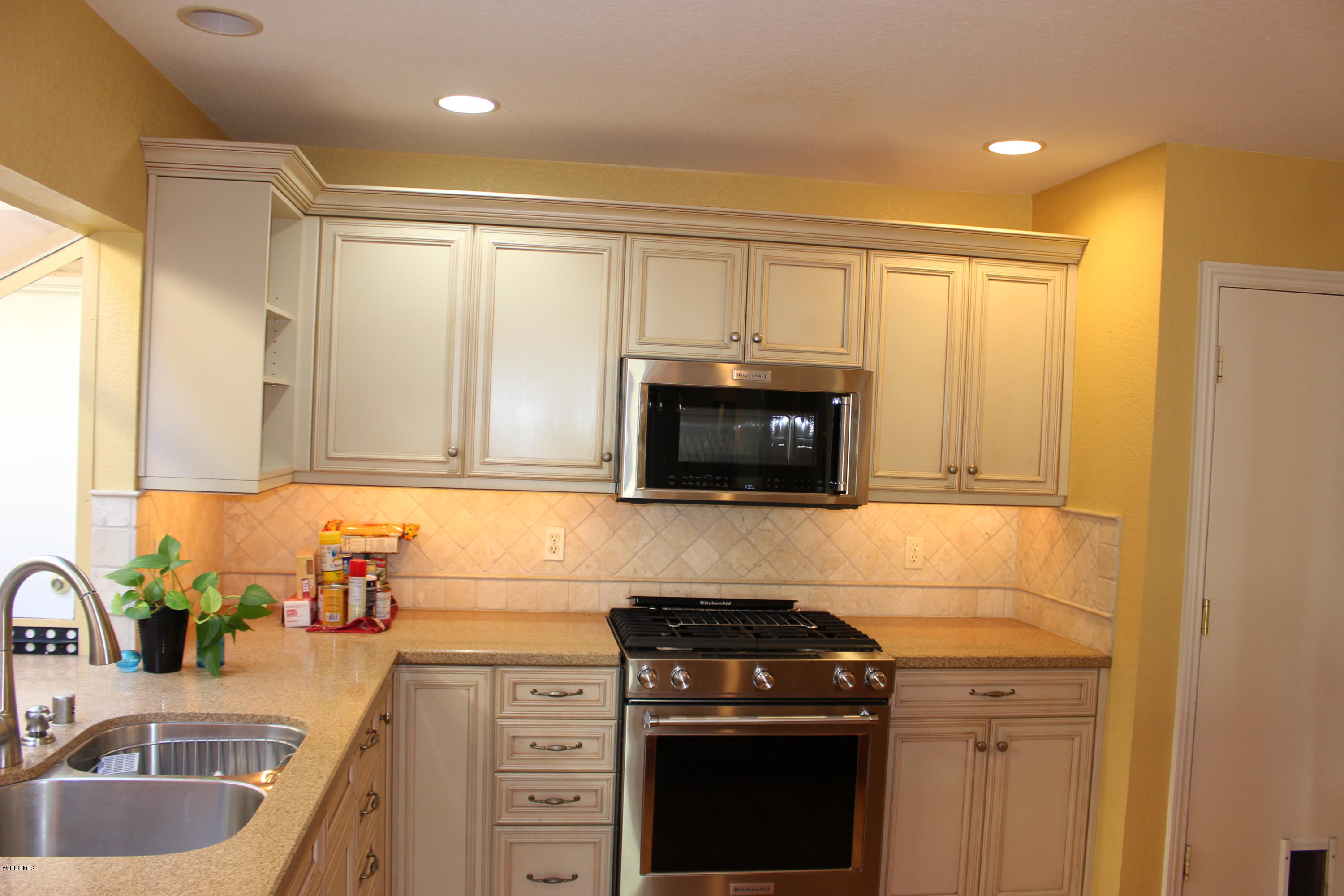 605 Galloping Hill Road Simi Valley, CA 93065 - Photo 10 of 35 a kitchen with granite countertop a sink stainless steel appliances and cabinets