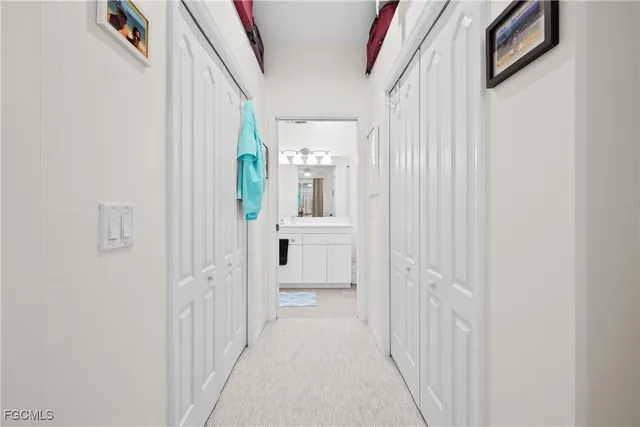 a view of a hallway with wooden floor and entryway