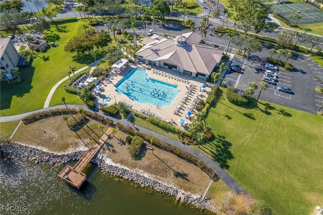 an aerial view of a house with a yard and lake view