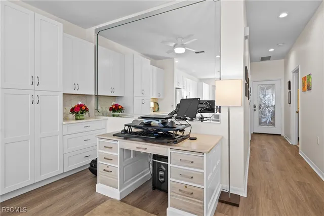 a kitchen with stainless steel appliances white cabinets and a stove top oven