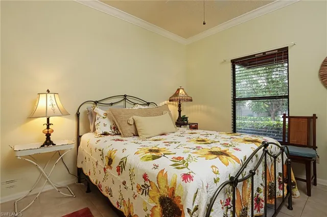 a bedroom with a bed and large windows