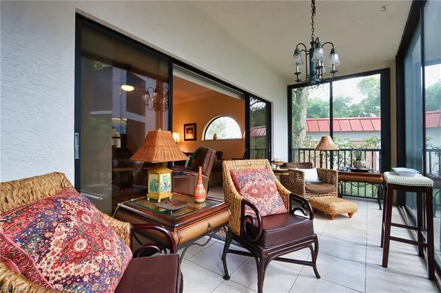 a living room with furniture and a floor to ceiling window