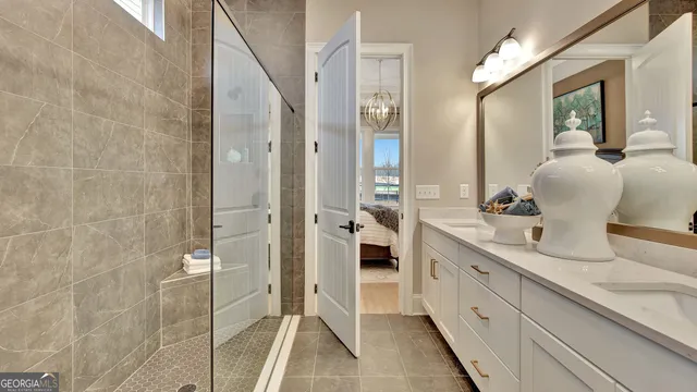 a bathroom with a double vanity sink mirror and shower