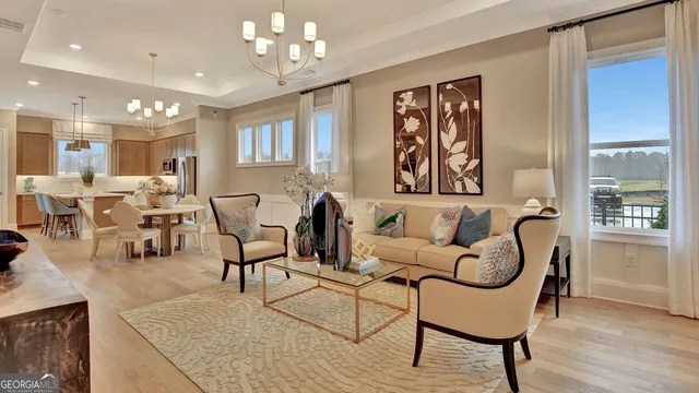 a living room with furniture potted plant and windows