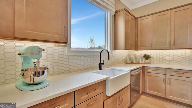 a kitchen with sink and cabinets