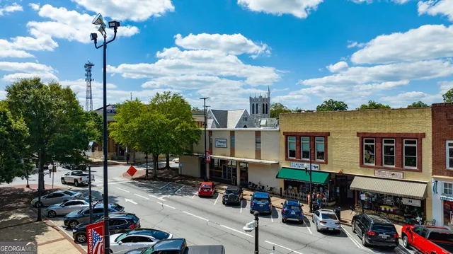 a city street lined with buildings and cars