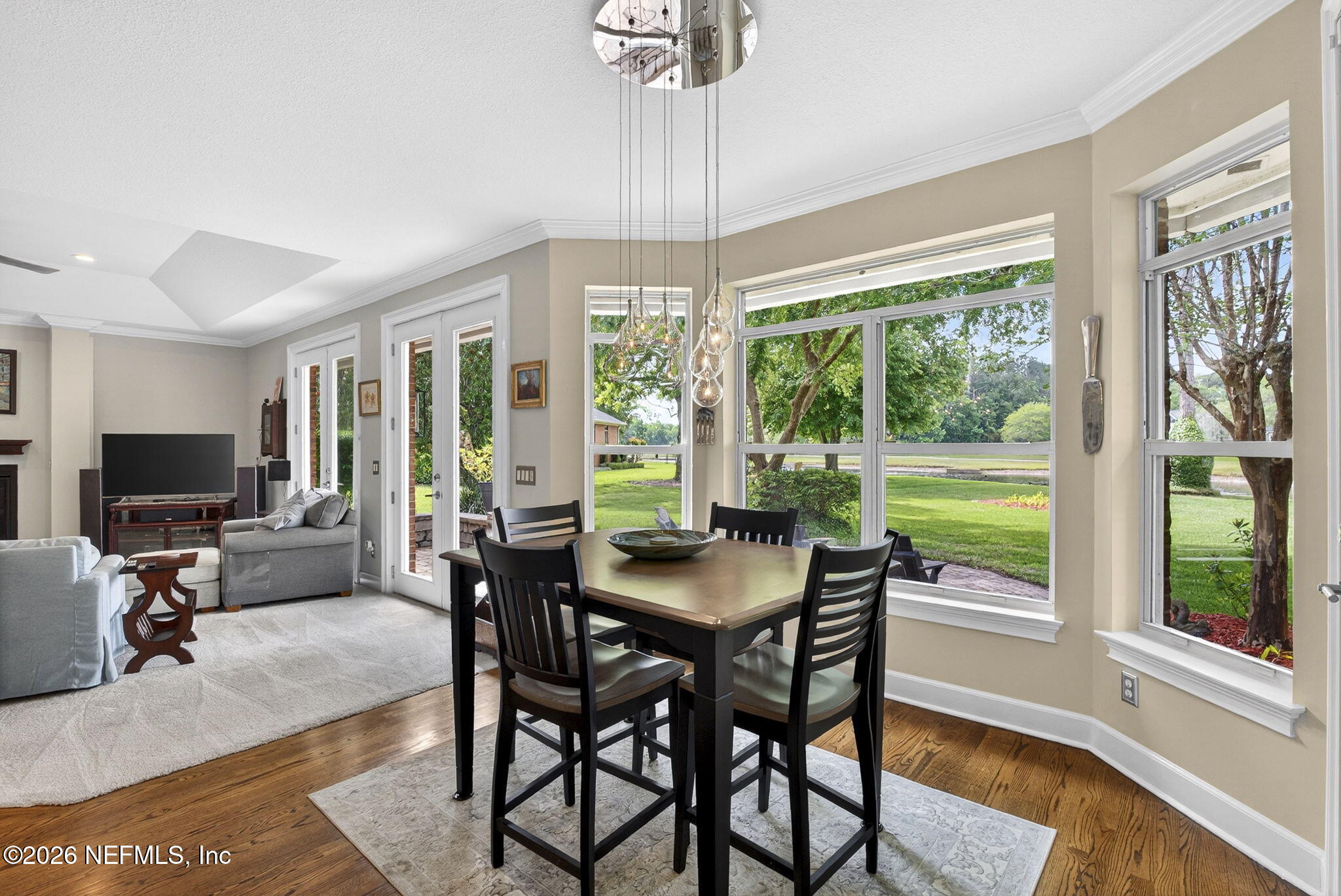 7914 Mc Laurin Road North Jacksonville, FL 32256 - Photo 12 of 44 a dining room with furniture a chandelier and wooden floor