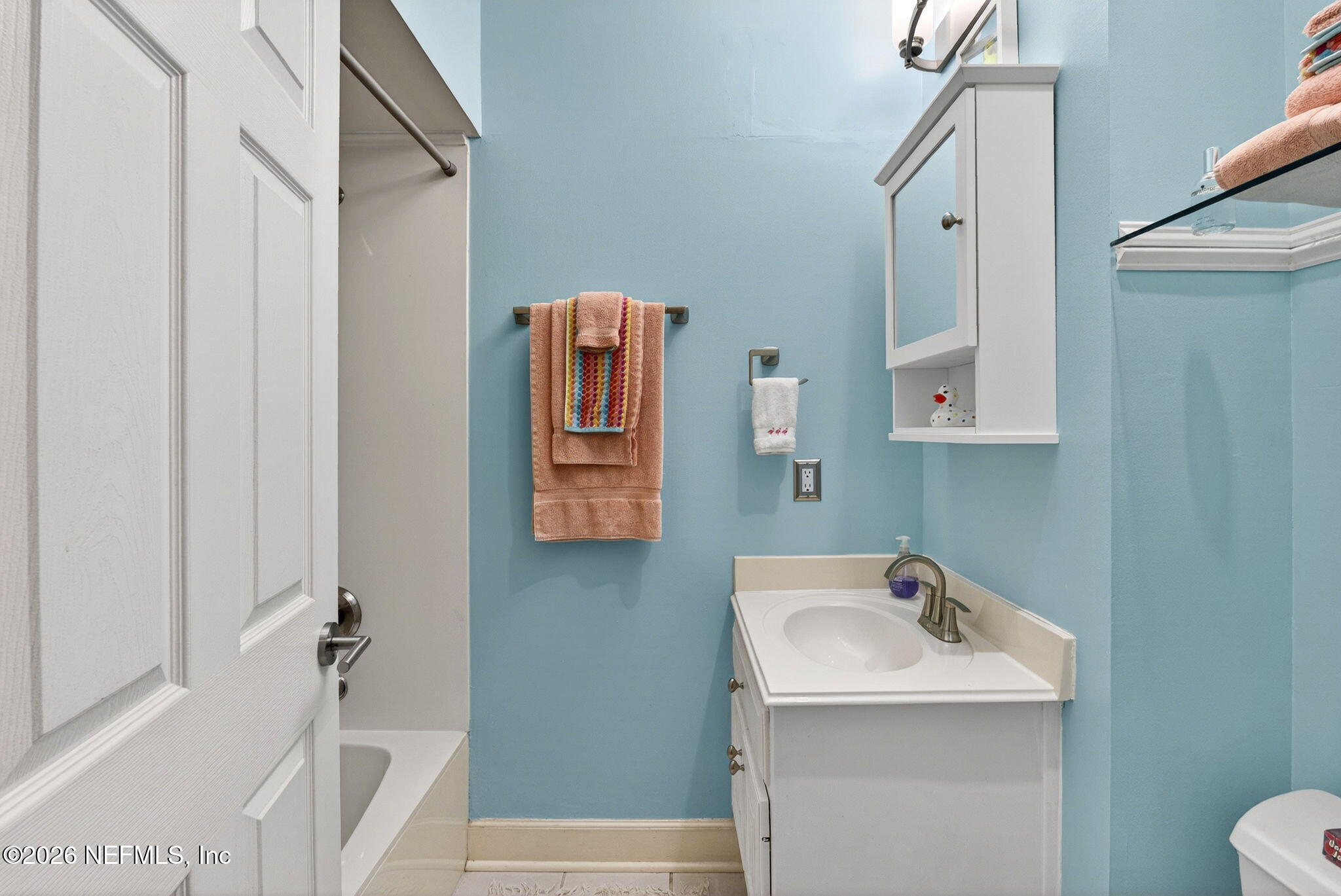 7914 Mc Laurin Road North Jacksonville, FL 32256 - Photo 26 of 44 a bathroom with a sink and mirror with toilet