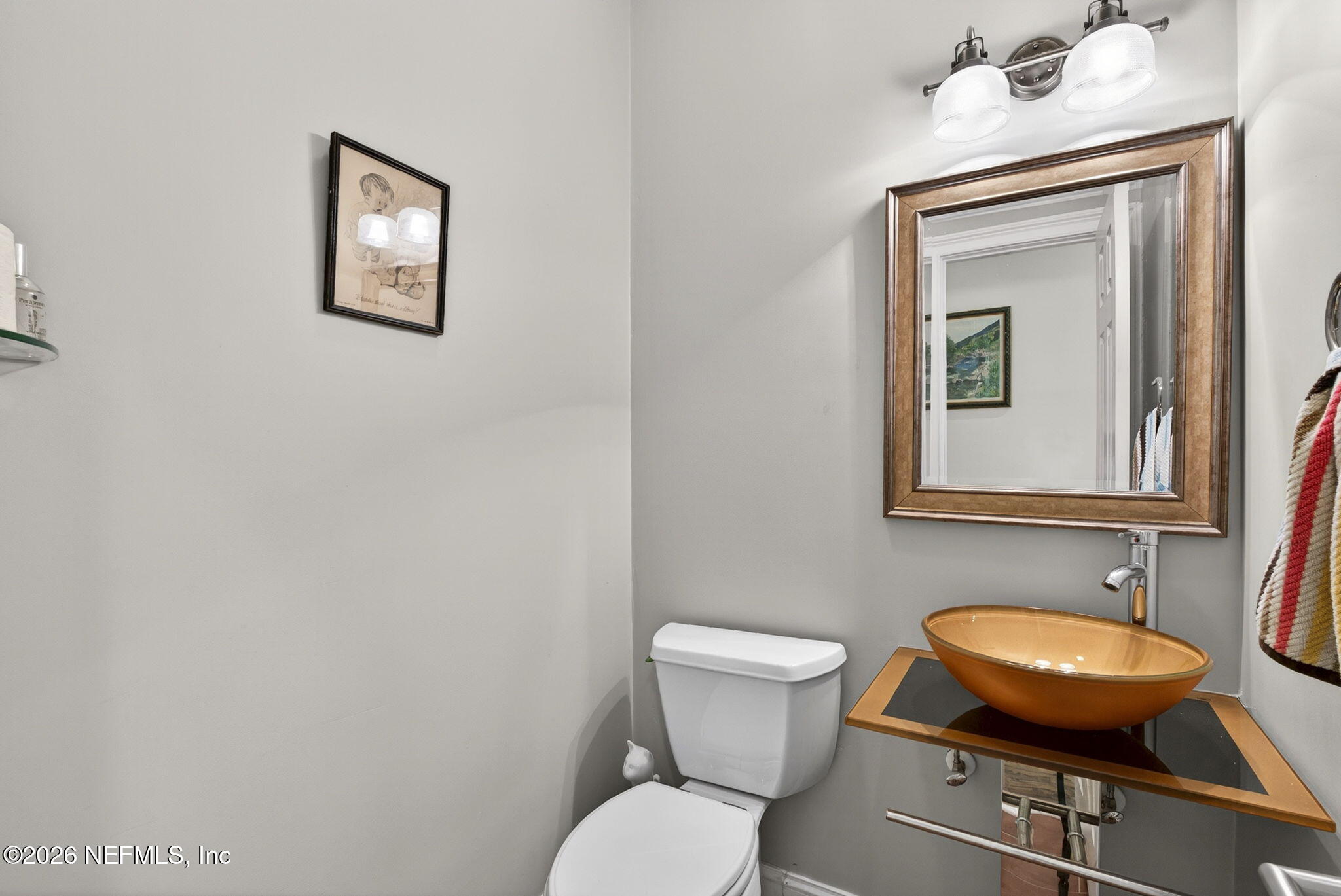 7914 Mc Laurin Road North Jacksonville, FL 32256 - Photo 27 of 44 a bathroom with a toilet a sink and mirror