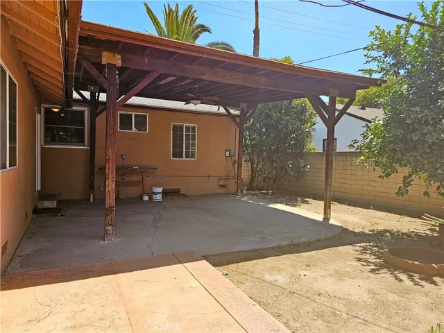a backyard of a house with table and chairs