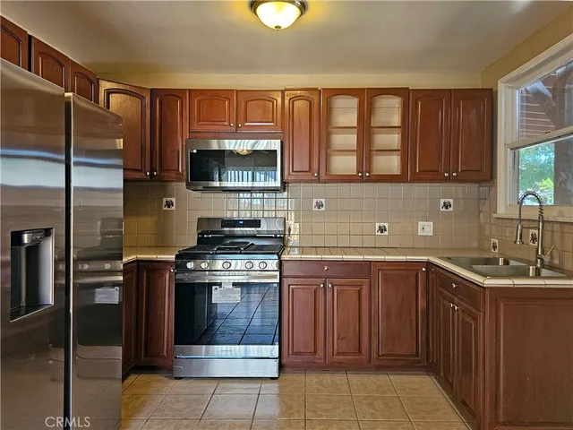 a kitchen with a stove sink and cabinets