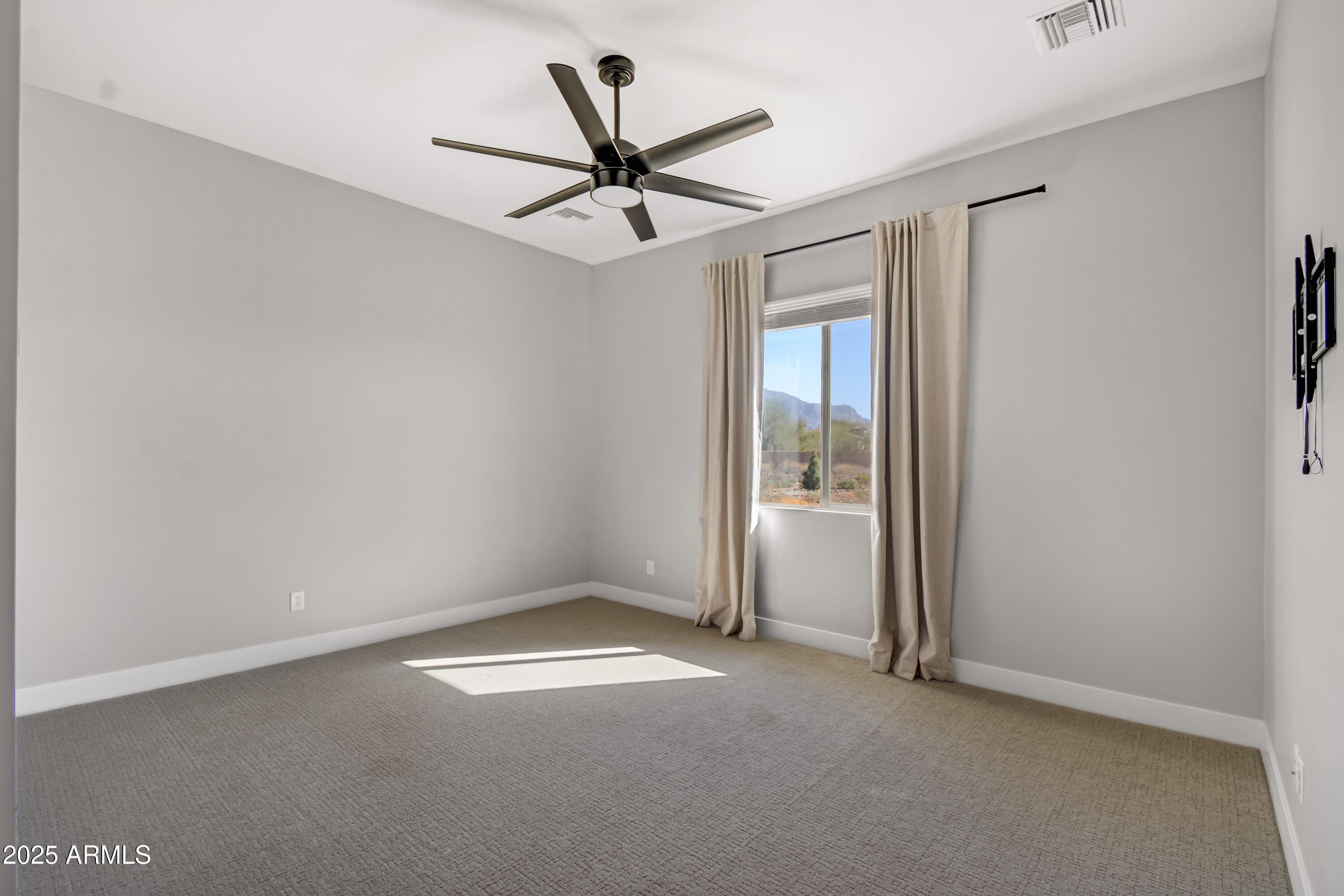 2775 South Baker Apache Junction, AZ 85118 - Photo 28 of 47 an empty room with closet and a ceiling fan