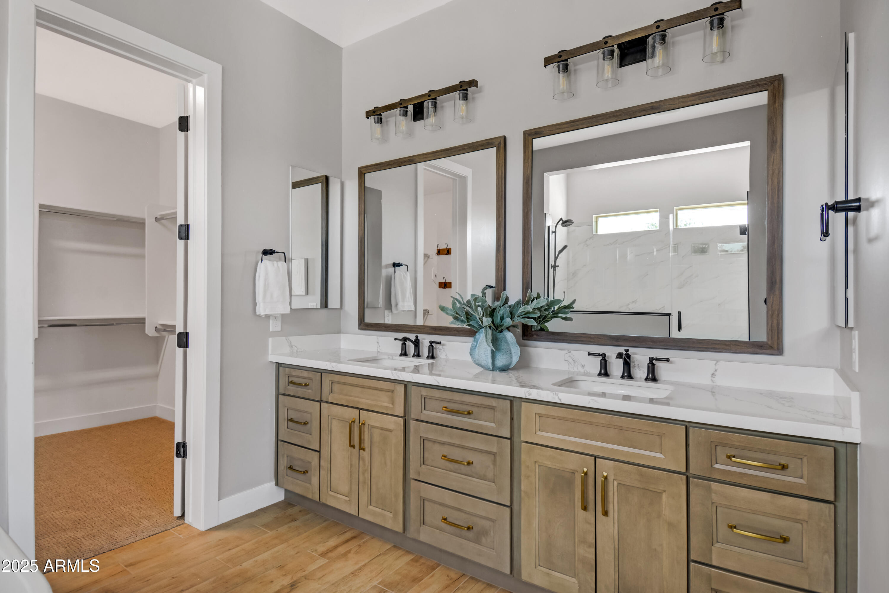 2775 South Baker Apache Junction, AZ 85118 - Photo 34 of 47 a bathroom with double vanity sink a two mirror a window and a bathtub