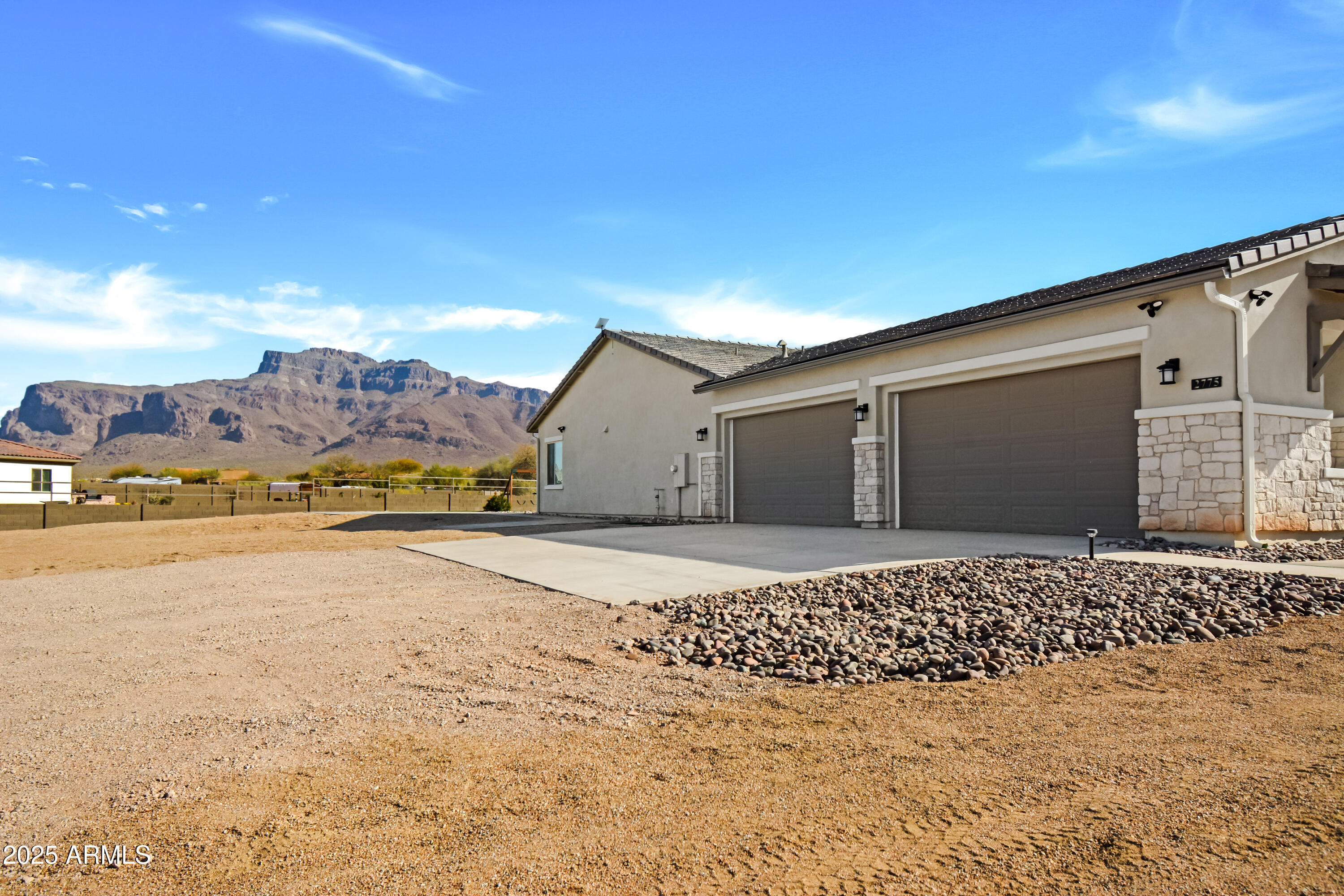 2775 South Baker Apache Junction, AZ 85118 - Photo 5 of 47 a front view of a house with a yard and mountain view in back