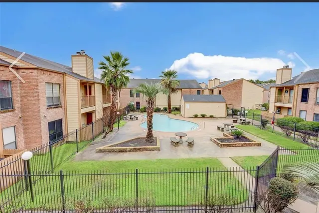 a view of a house with backyard porch and sitting area