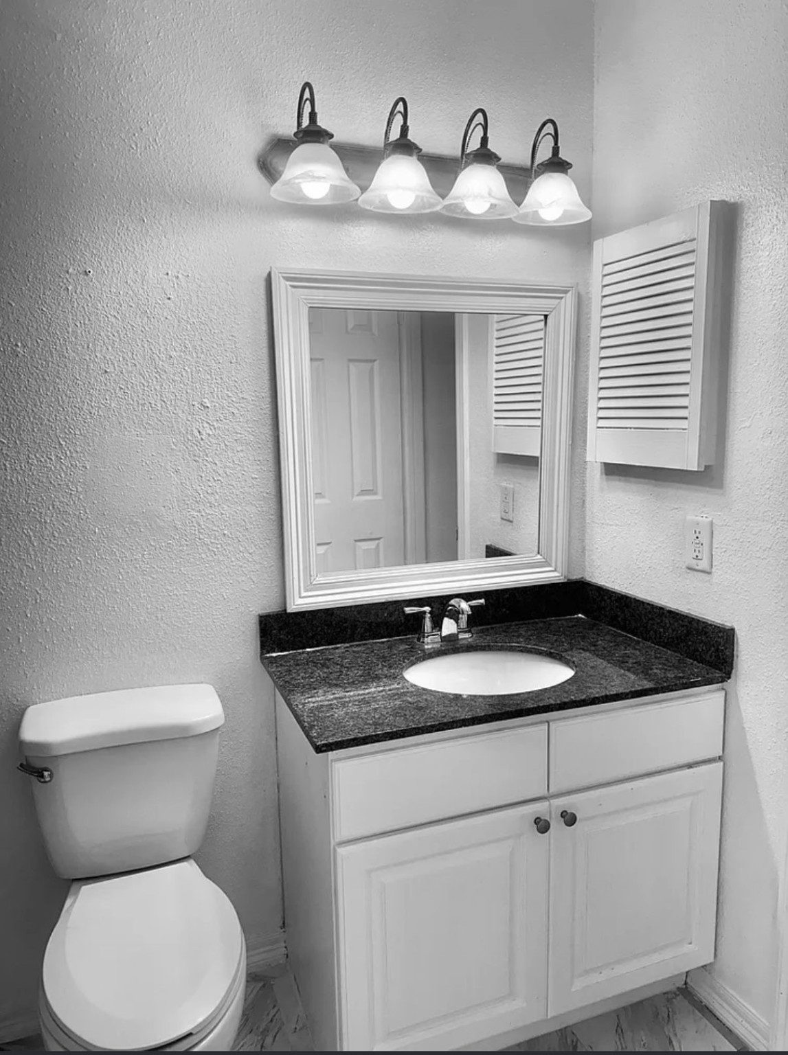 16111 Aspenglenn Drive, Unit 407 Houston, TX 77084 - Photo 14 of 15 a bathroom with a granite countertop sink and a toilet