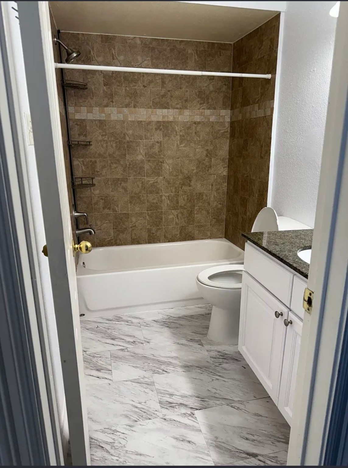 16111 Aspenglenn Drive, Unit 407 Houston, TX 77084 - Photo 15 of 15 a bathroom with a toilet and a shower