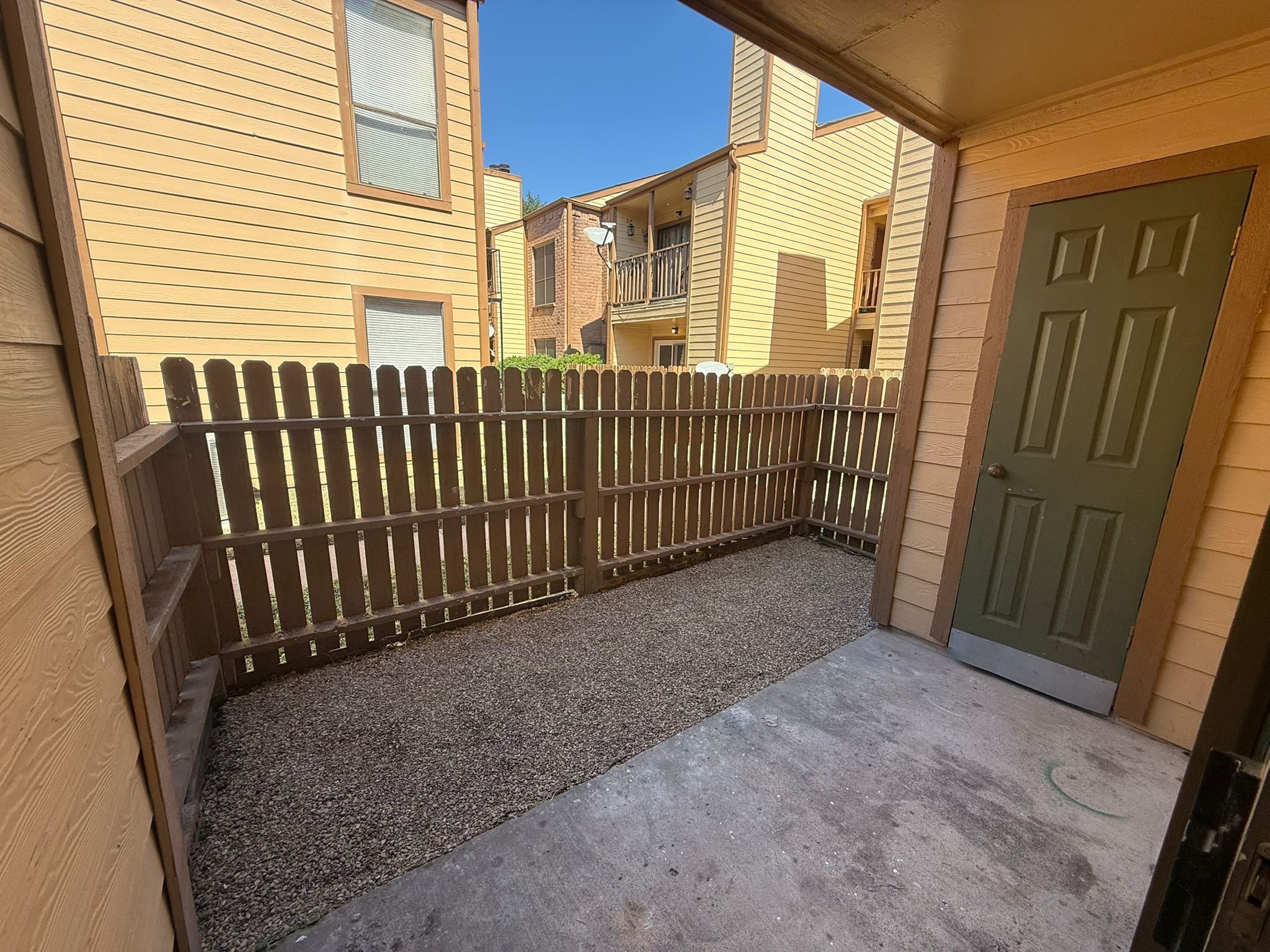 16111 Aspenglenn Drive, Unit 407 Houston, TX 77084 - Photo 3 of 15 a view of a porch with a door and wooden fence