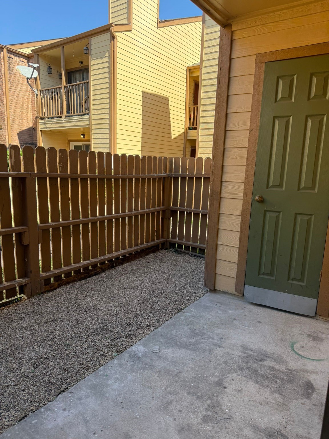 16111 Aspenglenn Drive, Unit 407 Houston, TX 77084 - Photo 4 of 15 a view of a house with a wooden fence