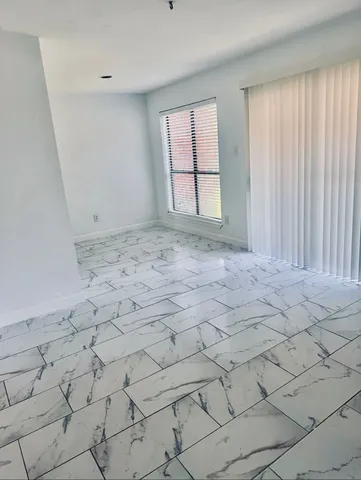 a view of empty room with windows