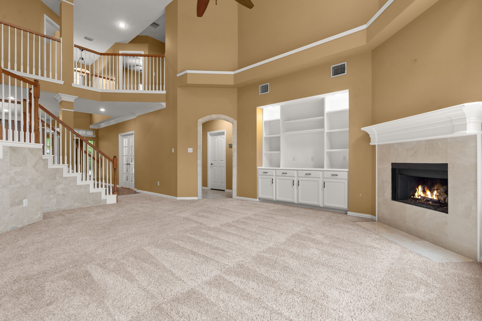 13258 Overlook Court Conroe, TX 77302 - Photo 11 of 49 Living room features corner fireplace and bookshelves for storage