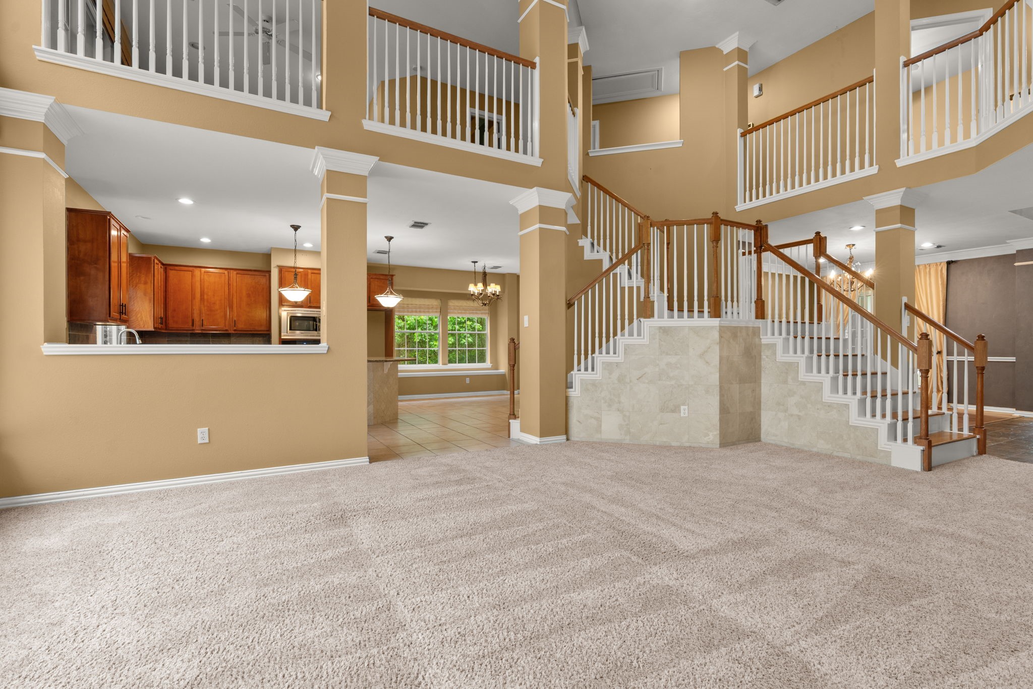 13258 Overlook Court Conroe, TX 77302 - Photo 12 of 49 Living room with view into the kitchen and notice the double entry staircase.