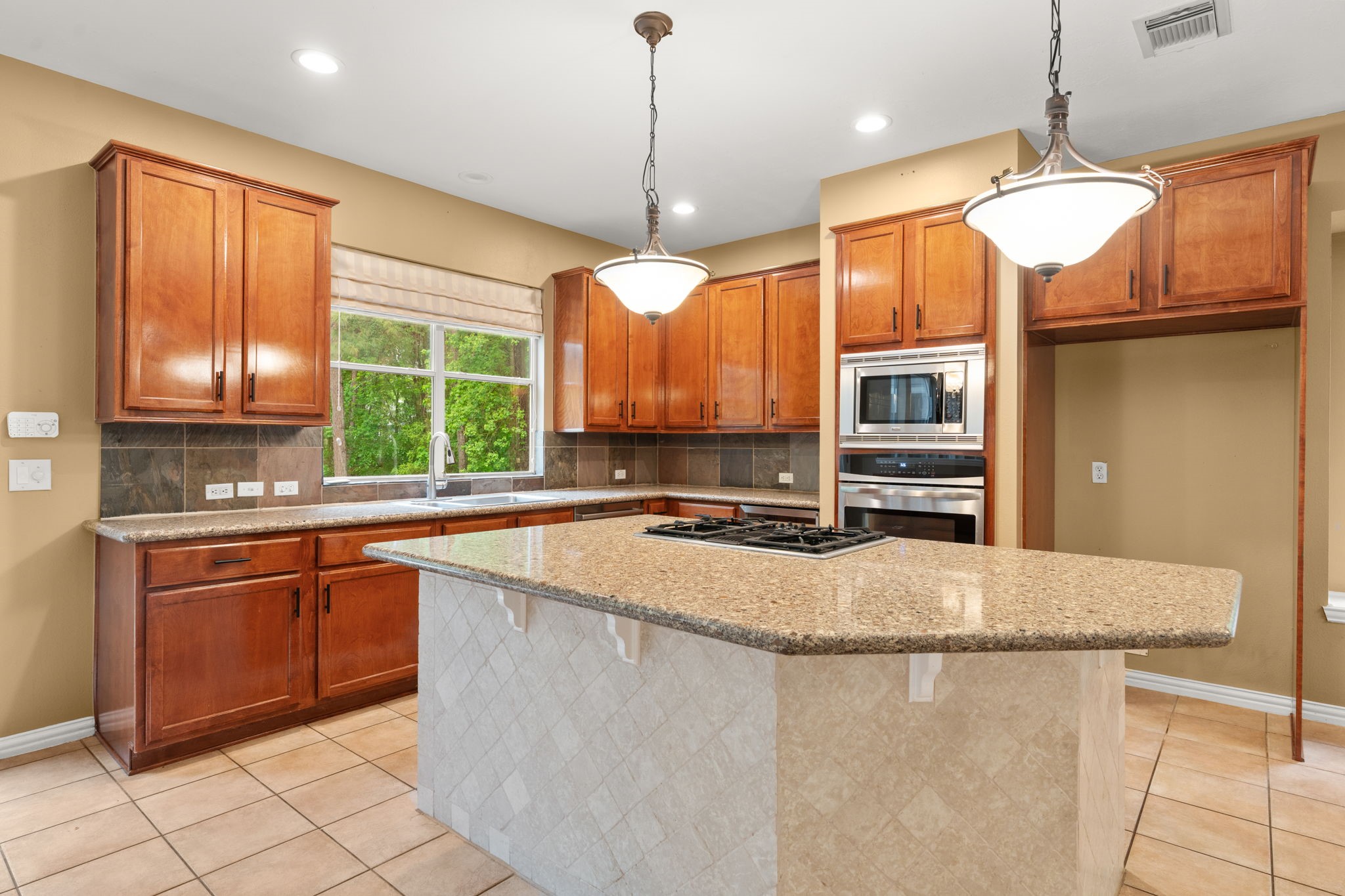 13258 Overlook Court Conroe, TX 77302 - Photo 14 of 49 Island kitchen with gas cooktop.
