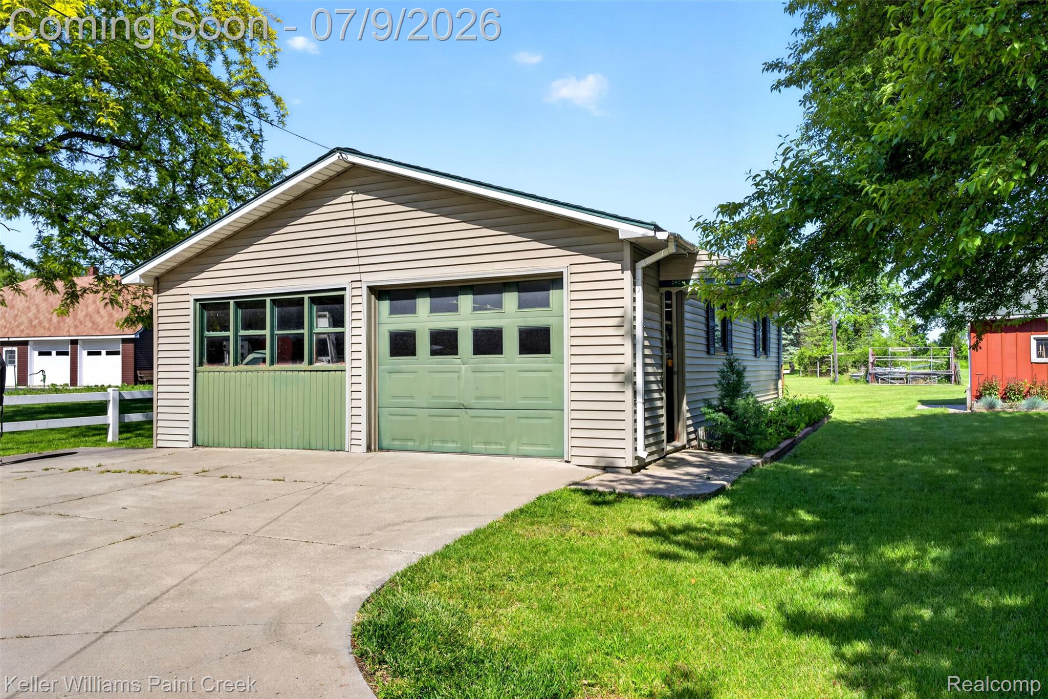 204 Russell Road Kawkawlin, MI 48631 - Photo 74 of 82 Two-car detached garage with green paneled doors and siding