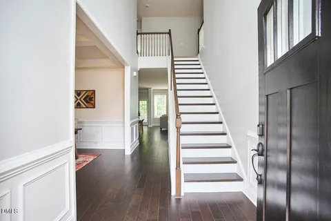 a view of entryway and hall with wooden floor