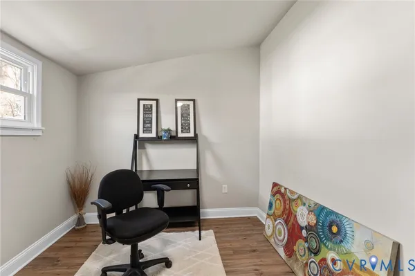 a reading room with furniture and wooden floor