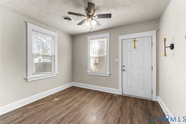 wooden floor in an empty room with a window