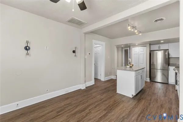 a view of kitchen with refrigerator microwave and wooden floor