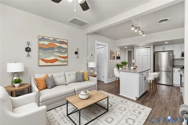 a living room with furniture and kitchen view