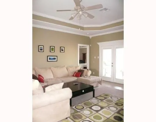 a living room with furniture and a chandelier