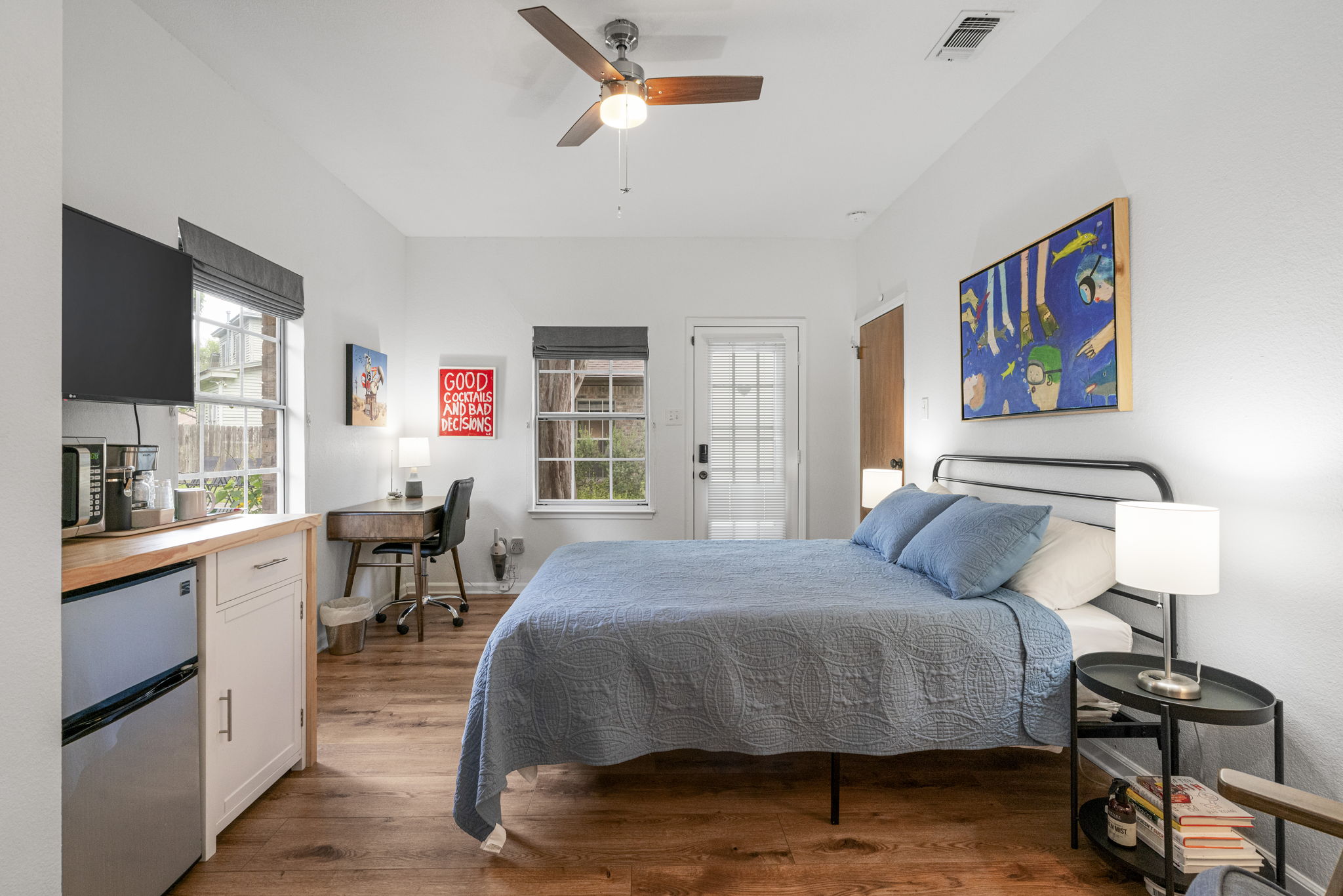 400 Hackberry Street Lockhart, TX 78644 - Photo 21 of 40 Well-lit sleeping quarters with a charming exterior door and hardwood-style flooring.