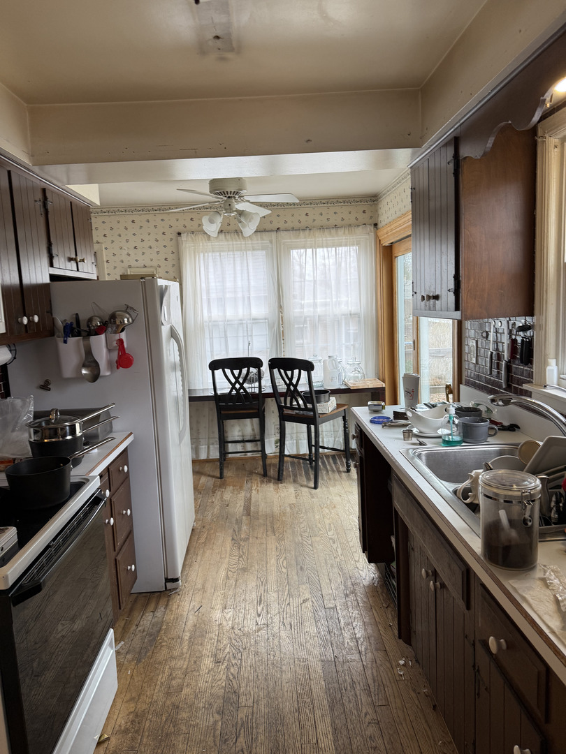 4N542 Church Road Bensenville, IL 60106 - Photo 6 of 6 a kitchen with stainless steel appliances granite countertop a sink stove and refrigerator