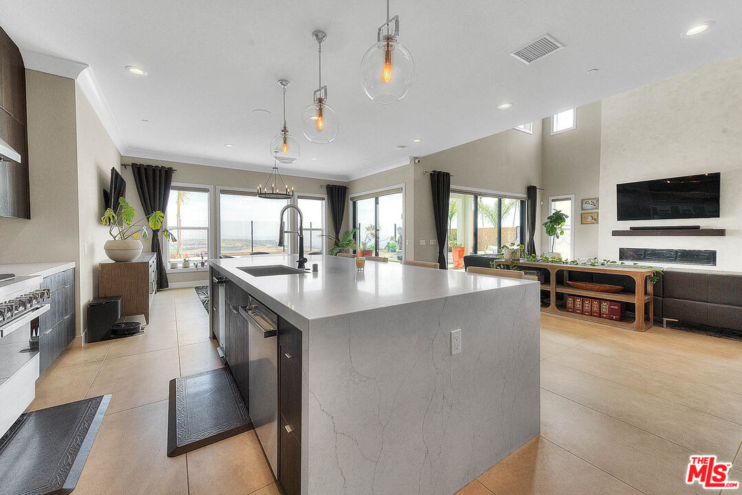 20558 Overlook Court Porter Ranch, CA 91326 - Photo 11 of 48 a kitchen with counter top space and living room view