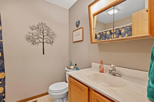 a bathroom with a sink a toilet and a mirror