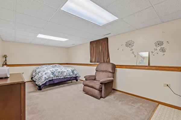 a bedroom with a bed and a couch