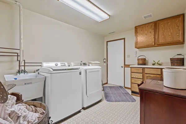a utility room with cabinets washer and dryer