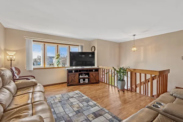 a living room with furniture tv and a window