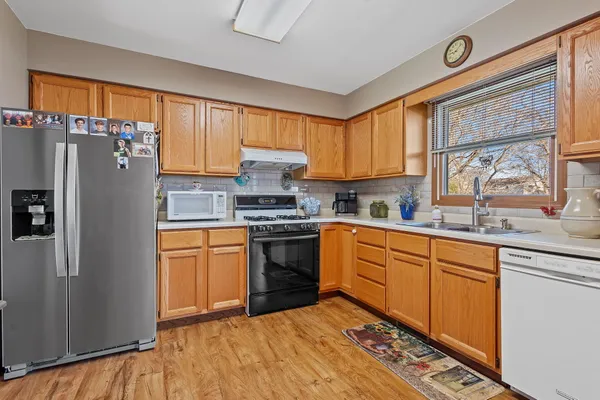a kitchen with stainless steel appliances a refrigerator sink and cabinets