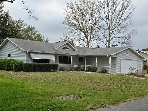 a front view of house with yard and green space