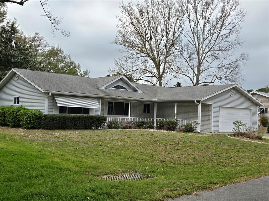 11510 Southwest 85th Court Ocala, FL 34481 - Photo 1 of 39 a front view of house with yard and green space