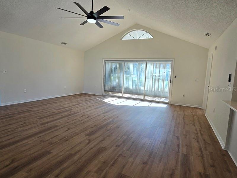 11510 Southwest 85th Court Ocala, FL 34481 - Photo 11 of 39 an empty room with wooden floor and windows