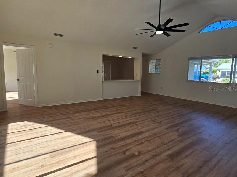 11510 Southwest 85th Court Ocala, FL 34481 - Photo 12 of 39 a view of a room with wooden floor and a ceiling fan