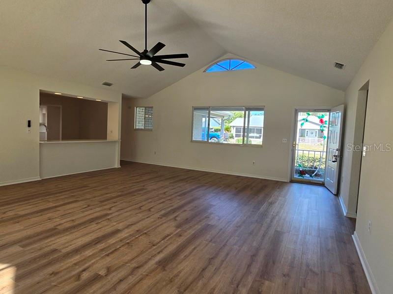 11510 Southwest 85th Court Ocala, FL 34481 - Photo 13 of 39 a view of a livingroom with wooden floor and a ceiling fan
