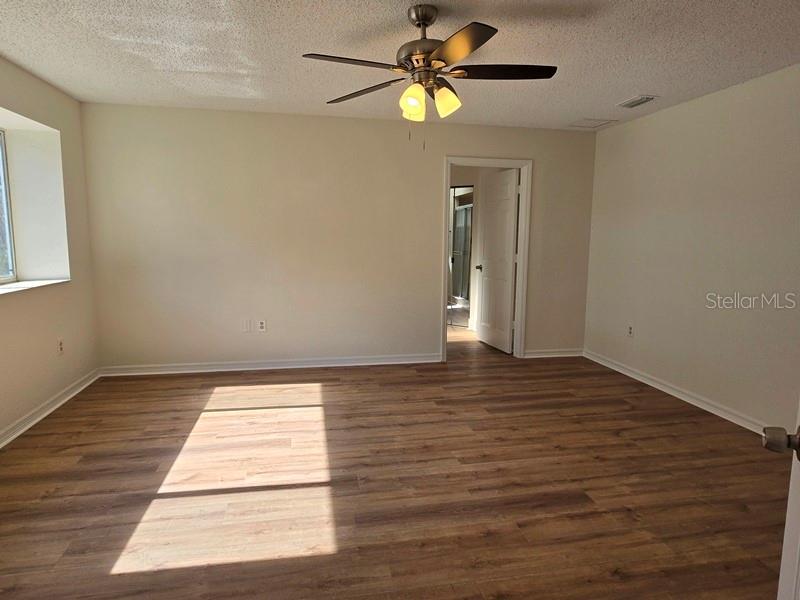 11510 Southwest 85th Court Ocala, FL 34481 - Photo 15 of 39 a view of an empty room with a window and wooden floor
